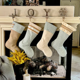 Set of four green ticking Farmhouse Christmas Stockings, to show the collection together.